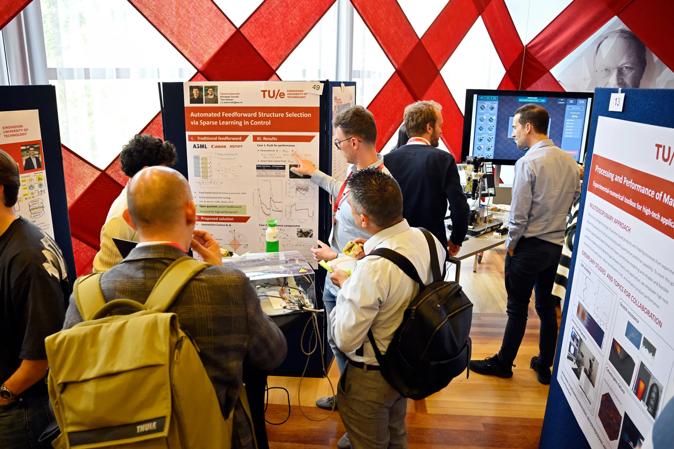 Attendees discussing a research poster